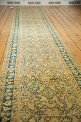 Distressed Persian Hamadan runner with beige Herati motifs and blue vine border.