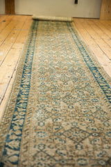 Distressed vintage Hamadan runner with textured indigo floral border and antique ivory Herati field.