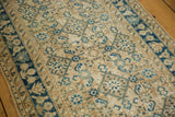 Close-up of distressed vintage Hamadan runner, beige and indigo Herati motif with visible wear.