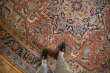Antique Serapi rug's field with delicate floral vinery, brick red, navy, and sky blue hues.