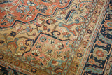 Antique Serapi carpet detail: delicate vinery, floral cross-sections, brick red, sky blue, and wear.