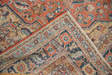 Antique Serapi carpet showing brick red field, fine blue floral border, and delicate vinery.