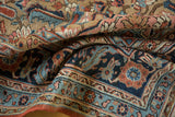 Antique Serapi rug: fine floral vinery and borders in navy, sky blue, and madder red.