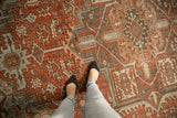 Distressed texture and geometric floral design in dusty terra cotta, powder blue on a vintage Heriz.