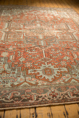 Distressed vintage Heriz carpet, geometric floral pattern, dusty terra cotta rust and pale blue.