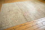 Vintage Tabriz carpet with distressed ivory, pale raspberry Rococo scrolling leaves and even wear.
