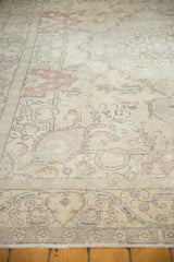 Distressed Tabriz border with delicate scrolling leaves in ivory, silver, and pale raspberry.