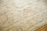 Worn pile on a distressed vintage Tabriz carpet, with muted Rococo patterns.
