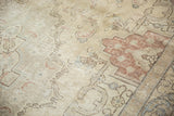 Distressed Tabriz carpet: even wear, visible foundation, muted ivory and blush Rococo patterns.