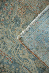 Distressed vintage Mahal carpet, worn muted pile, white fringe, light blue hand-knotted foundation.