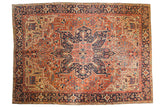 Antique Heriz carpet, oversized navy medallion, brick red field, geometric floral vinery.
