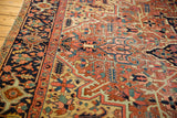 Antique Heriz carpet border, showing geometric vinery, floral elements, navy, brick red, and pale yellow.