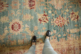 Oushak carpet highlighting distressed aqua, blush, wine floral pattern and abrashes.
