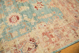 Intricate blush coral and antique ivory border with faded aqua field of a distressed Oushak carpet.