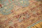 Distressed Oushak carpet's richly textured blush coral border and sky blue field.
