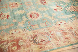 Distressed Oushak rug showcasing lovely abrashes, aqua blue field, and blush coral border pattern.
