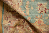 Textured pile and abrash on a new distressed Oushak rug with aqua and coral patterns.