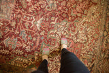 Distressed vintage Heriz carpet texture with geometric vinery, raspberry red, and seafoam green.
