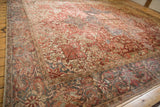 Distressed vintage Heriz geometric vinery and palmettes in raspberry red, ivory, and blue.