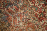 Distressed vintage Heriz rug showcasing geometric vinery, wine red, seafoam, faint foundation showing.
