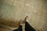 Distressed vintage Malayer carpet, showing faded pale blue field and intricate allover pattern.