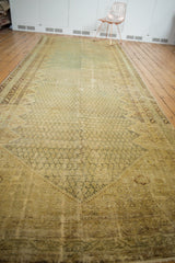 Long distressed Malayer carpet, allover boteh and serrated diamond motifs in muted tones, showing even wear.