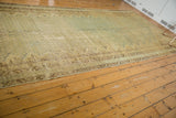Meandering vine border and distressed field patterns on a vintage Malayer carpet.