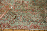 Distressed American Sarouk carpet border with scrolling Rococo floral motifs in raspberry and seafoam.