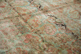 Artfully distressed American Sarouk carpet texture: muted seafoam background with rich raspberry floral motifs.