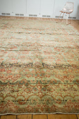 Textural details of the distressed Sarouk rug's faded floral bouquet and Rococo border.