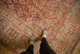 Distressed Joshegan carpet showing cinnabar red, blue, ivory, gold Gardens of Paradise pattern.