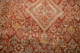 Distressed Joshegan carpet: cinnabar red field with lattice Gardens of Paradise motif.