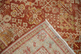 Distressed vintage Joshegan carpet showing faint foundation, secured edges, and fringe.