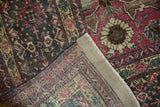 Distressed Tabriz carpet, showing worn pile, underlying foundation, and secured edge.