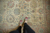 Evenly worn pile of a distressed Tabriz carpet with ivory, dusty rose, and slate blue florals.