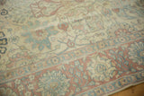 Close view of the distressed pile and Safavid-style border in dusty rose, slate blue, and antique ivory.