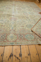 Low-angle view showing the soft, distressed texture and muted colors of a vintage Tabriz carpet.