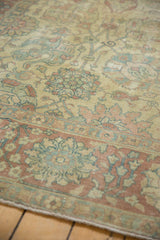 Worn pile on a distressed Tabriz carpet with faint foundation showing through Safavid floral motifs.