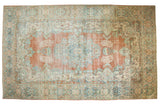Vintage distressed Mahal carpet with a faded brick, blue, and ivory Rococo medallion design.