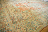 Vibrant brick orange, blue, and ivory Rococo floral patterns on a distressed vintage Mahal rug.