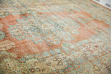 Vintage distressed Mahal rug detail: brick orange, powder blue, ivory Rococo floral pattern and wear.