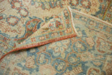 Distressed pile texture of vintage Mahal carpet, revealing faint foundation and brick-blue motifs.