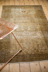 Distressed vintage Hamadan rug in softened gold, olive, and ivory, with classic Samovar border.