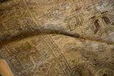 Distressed Hamadan rug detail, showing gold, beige pile with exposed foundation.