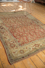 Rustic fringe and worn texture of the distressed Bijar rug with faded Herati motifs.