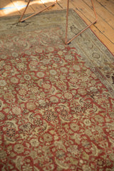 Corner detail of an antique Bijar rug showcasing distressed Herati motifs, faint foundation, and turtle border.