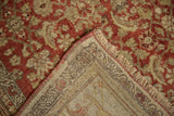 Folded corner of antique distressed Bijar rug, showing hand-knotted foundation and worn rust, ivory pile.