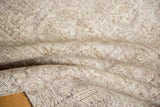 Distressed pile texture showing worn knot heads on the vintage Sparta carpet.