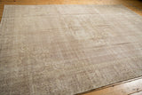 Distressed pile of the vintage Sparta carpet, showing mostly even wear and faded pale motifs.
