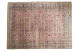 Distressed pink vintage Turkish Sparta carpet with allover palmette design and indigo blue borders.